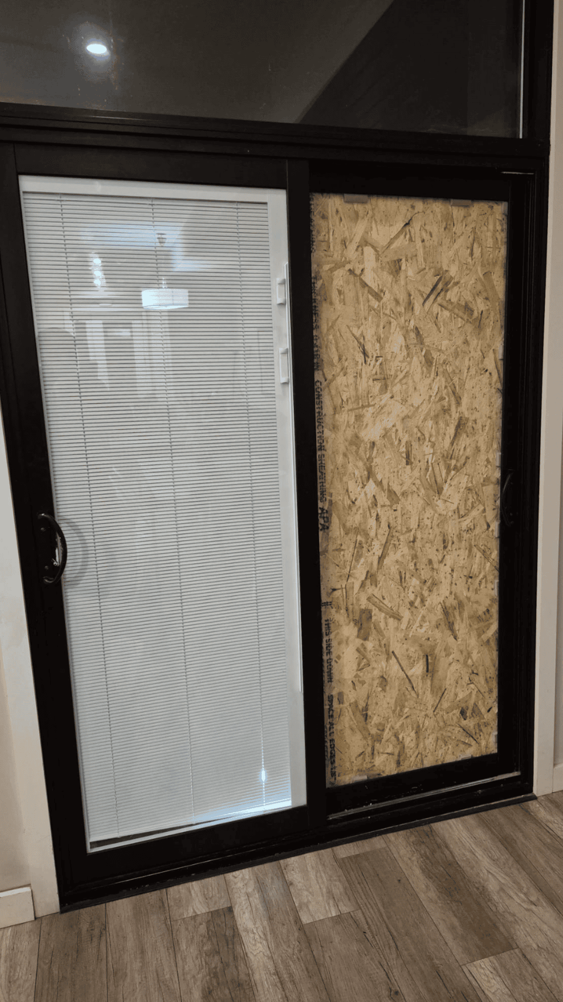 A finished commercial glass entry door at a retail unit, clear and installed